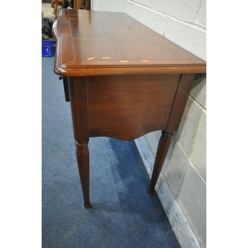 1244 - A CHERRYWOOD SIDE TABLE, fitted with an arrangement of four drawers, raised on cylindrical tapered l... 