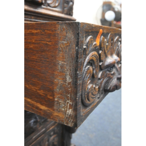 1250 - A 20TH CENTURY OAK CARVED GREEN MAN TWIN PEDESTAL DESK, with leather writing surface, fitted with an... 