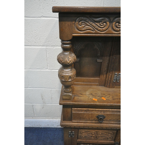 1251 - AN OLD CHARM OAK COURT CUPBOARD, fitted with double lead glazed doors, turned supports, three drawer... 