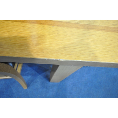 1255 - MORRIS FURNITURE, A SOLID OAK RECTANGULAR EXTENDING DINING TABLE, with one additional leaf, extended... 