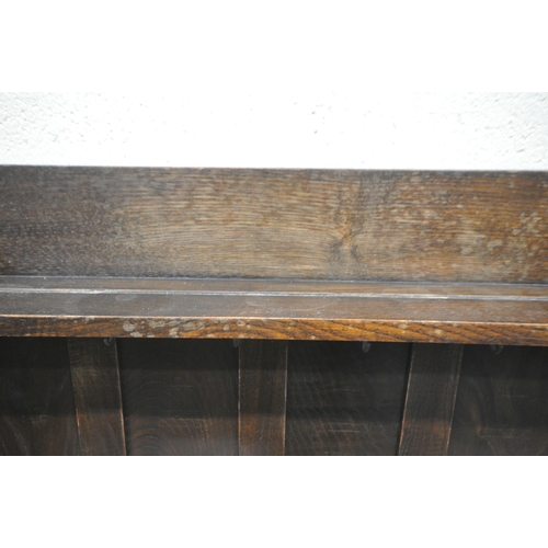 1256 - AN EARLY 20TH CENTURY OAK DRESSER, the two tier plate rack, with wavy sides, atop a base with two dr... 