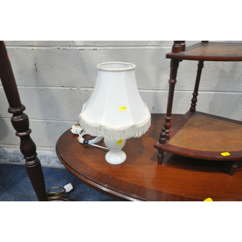 1269 - A MAHOGANY OVAL COFFEE TABLE, a four tier corner what-not, an oval mirror, a standard lamp and a tab... 