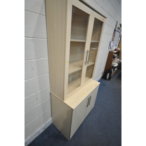 1271 - A MODERN BEECH EFFECT CABINET, the top section with double glazed doors, that are enclosing two shel... 