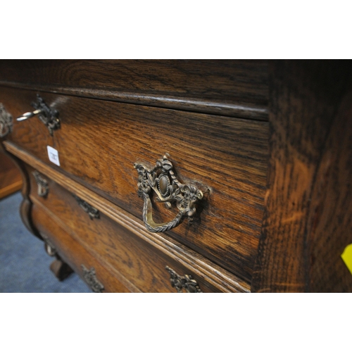 1287 - A 20TH CENTURY OAK BOMBE CHEST OF THREE DRAWERS, raised on ball and claw feet, width 78cm x depth 42... 