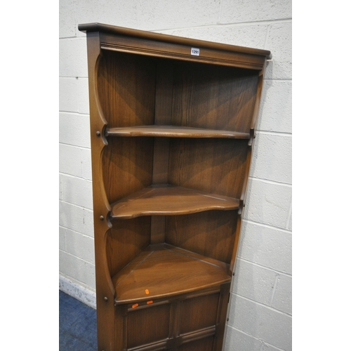 1291 - LUCIAN ERCOLANI, A MID CENTURY ELM AND BEECH OLD COLONIAL CORNER CUPBOARD, fitted with two fixed she... 