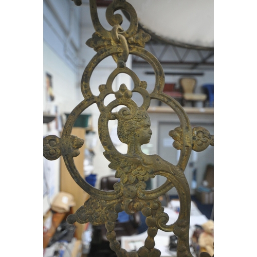 1293 - A 19TH CENTURY HANGING BRASS OIL LAMP, converted to electric, the flamboyant frame cradling a white ... 