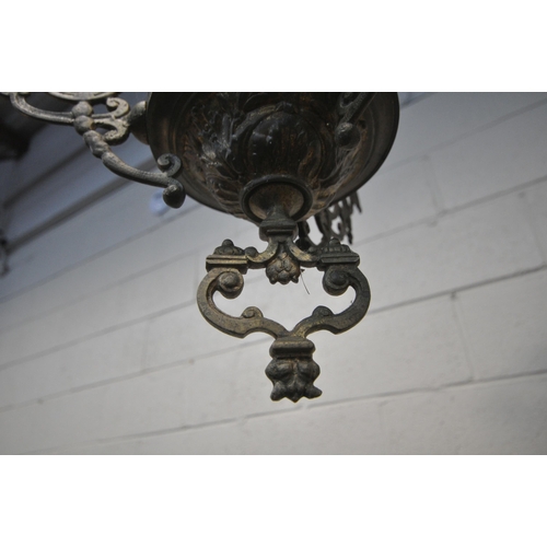 1293 - A 19TH CENTURY HANGING BRASS OIL LAMP, converted to electric, the flamboyant frame cradling a white ... 