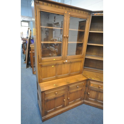 1300 - LUCIAN ERCOLANI, AN ELM AND BEECH CORNER WALL CABINET, fitted with an arrangement of glazed doors, c... 