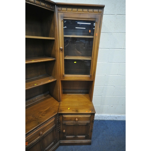 1300 - LUCIAN ERCOLANI, AN ELM AND BEECH CORNER WALL CABINET, fitted with an arrangement of glazed doors, c... 