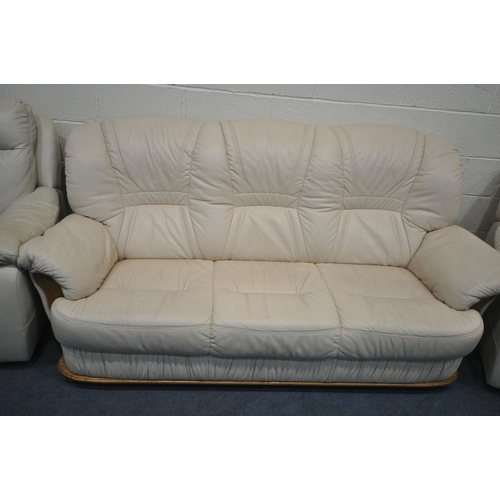 1317 - A CREAM LEATHER THREE SEATER SOFA, length 208cm x depth 99cm x height 96cm, along with a pair of arm... 