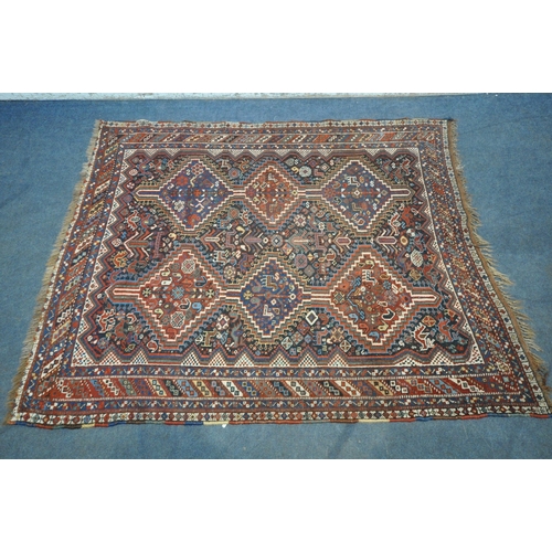 1318 - A LATE 19TH CENTURY QASHKAI HAND WOVEN WOOL RUG, with six medallions, repeating geometric designs, m... 