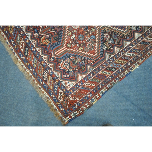 1318 - A LATE 19TH CENTURY QASHKAI HAND WOVEN WOOL RUG, with six medallions, repeating geometric designs, m... 