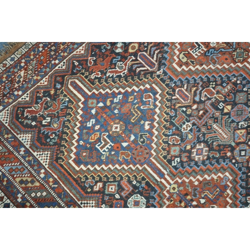 1318 - A LATE 19TH CENTURY QASHKAI HAND WOVEN WOOL RUG, with six medallions, repeating geometric designs, m... 