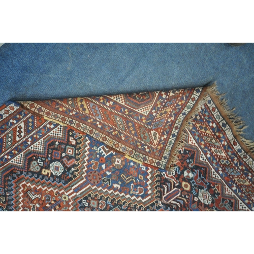 1318 - A LATE 19TH CENTURY QASHKAI HAND WOVEN WOOL RUG, with six medallions, repeating geometric designs, m... 