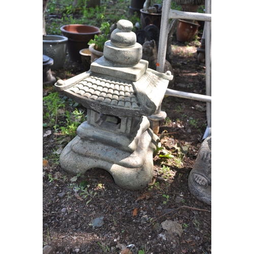 1013 - THREE MODERN ORIENTAL STYLE GARDEN ORNAMENTS including a modern composite Pagoda height 60cm, a Budd... 