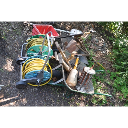 1018 - A SELECTION OF GARDEN TOOLS including two wheel barrows (one tyre flat), two hose reels, shovels, sp... 