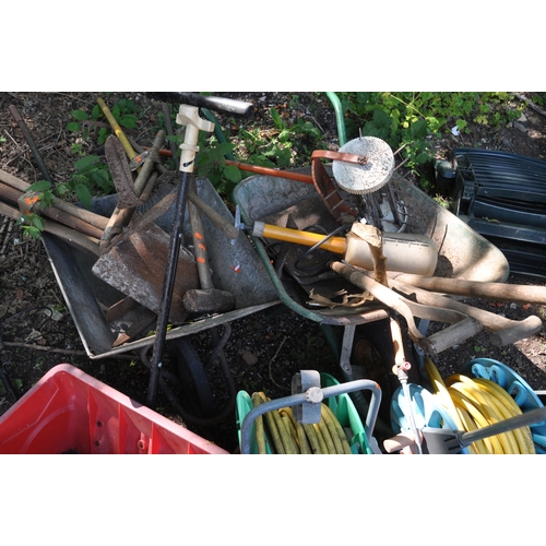 1018 - A SELECTION OF GARDEN TOOLS including two wheel barrows (one tyre flat), two hose reels, shovels, sp... 