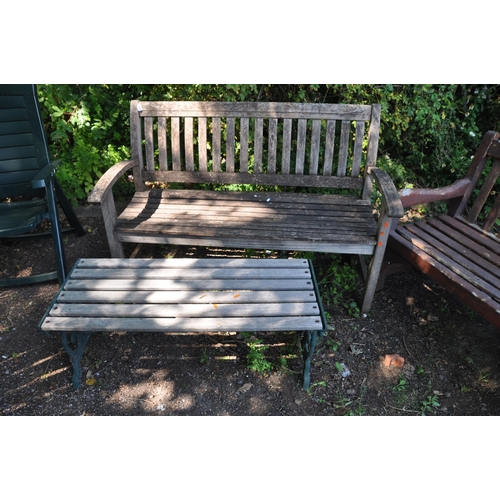 1020 - A MODERN HARDWOOD GARDEN BENCH width 139cm with slatted back and seat along with a modern cast iron ... 