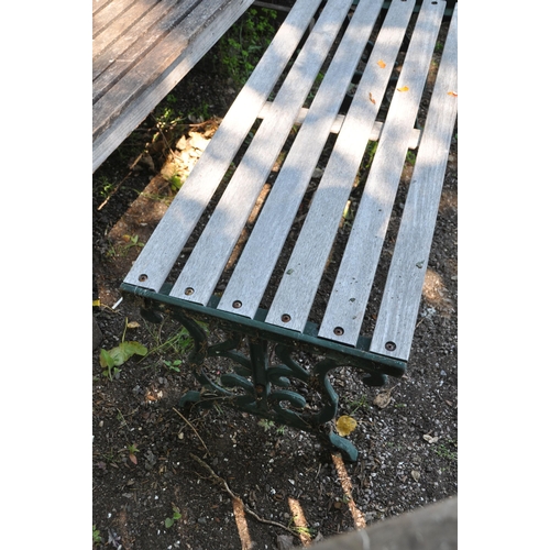 1020 - A MODERN HARDWOOD GARDEN BENCH width 139cm with slatted back and seat along with a modern cast iron ... 