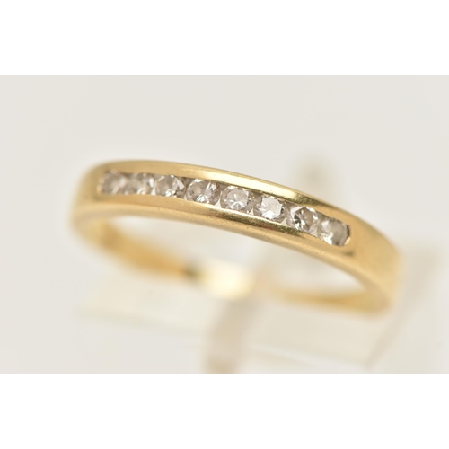 10 - A YELLOW METAL DIAMOND BAND RING, eight round brilliant cut diamonds, channel set in yellow metal, a... 