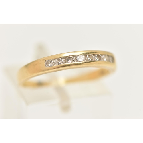 10 - A YELLOW METAL DIAMOND BAND RING, eight round brilliant cut diamonds, channel set in yellow metal, a... 