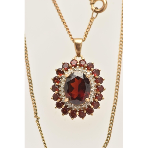 23 - A 9CT GOLD GEM SET NECKLACE, an oval cut garnet prong set with a surround of diamonds and garnets, f... 