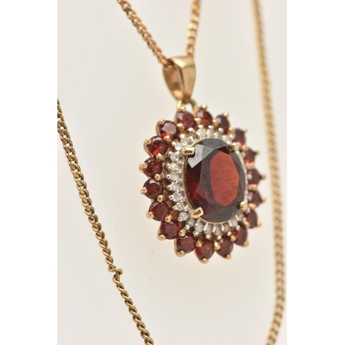 23 - A 9CT GOLD GEM SET NECKLACE, an oval cut garnet prong set with a surround of diamonds and garnets, f... 