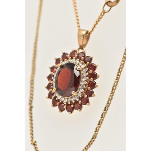 23 - A 9CT GOLD GEM SET NECKLACE, an oval cut garnet prong set with a surround of diamonds and garnets, f... 