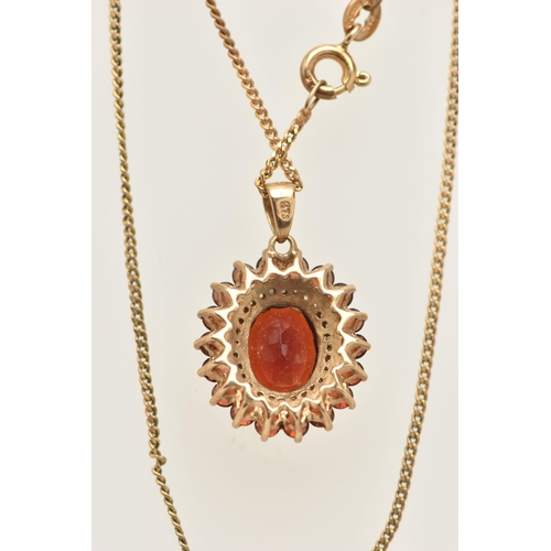 23 - A 9CT GOLD GEM SET NECKLACE, an oval cut garnet prong set with a surround of diamonds and garnets, f... 