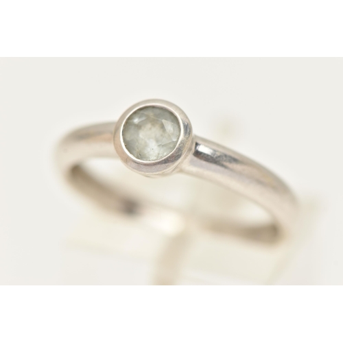 26 - A 9CT WHITE GOLD GEM SET RING, designed as a circular aquamarine in a collet setting to the plain ba... 