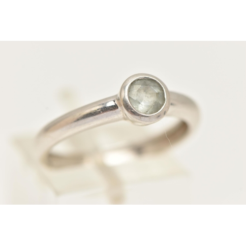 26 - A 9CT WHITE GOLD GEM SET RING, designed as a circular aquamarine in a collet setting to the plain ba... 