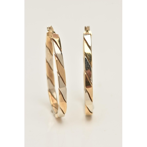 31 - A PAIR OF 9CT BI-COLOUR HOOP EARRINGS, oval hoops with alternating yellow and white gold, lever post... 