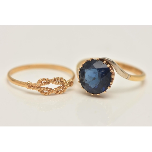 33 - TWO YELLOW METAL RINGS, the first set with a circular cut blue paste, claw setting to cross over sho... 