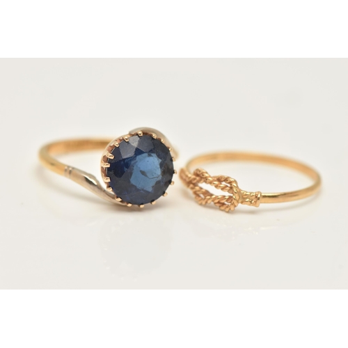 33 - TWO YELLOW METAL RINGS, the first set with a circular cut blue paste, claw setting to cross over sho... 