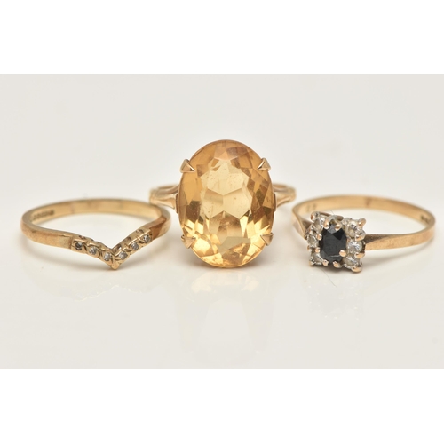 34 - THREE 9CT GOLD RINGS, the first set with an oval cut citrine in a four claw setting, open work galle... 