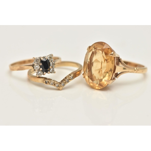 34 - THREE 9CT GOLD RINGS, the first set with an oval cut citrine in a four claw setting, open work galle... 