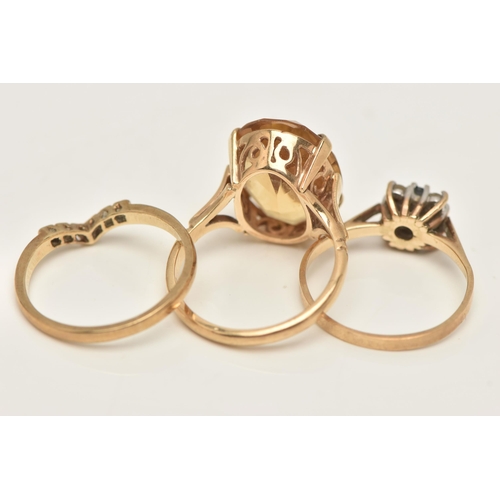 34 - THREE 9CT GOLD RINGS, the first set with an oval cut citrine in a four claw setting, open work galle... 