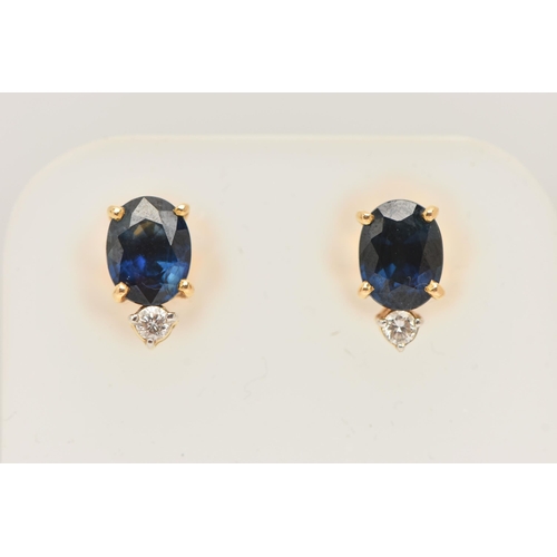 56 - A PAIR OF YELLOW METAL SAPPHIRE AND DIAMOND EARRINGS, each earring set with an oval cut blue sapphir... 