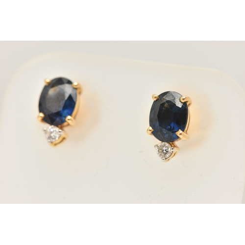 56 - A PAIR OF YELLOW METAL SAPPHIRE AND DIAMOND EARRINGS, each earring set with an oval cut blue sapphir... 