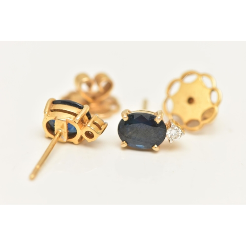 56 - A PAIR OF YELLOW METAL SAPPHIRE AND DIAMOND EARRINGS, each earring set with an oval cut blue sapphir... 