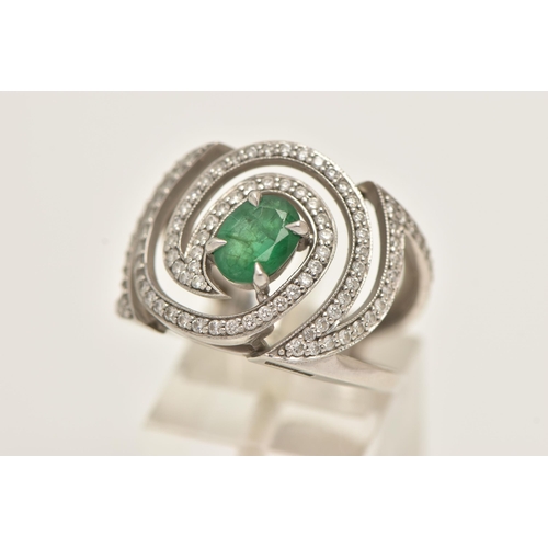 57 - A PLATINUM EMERALD AND DIAMOND DRESS RING, large dress ring set with a central oval cut emerald, in ... 