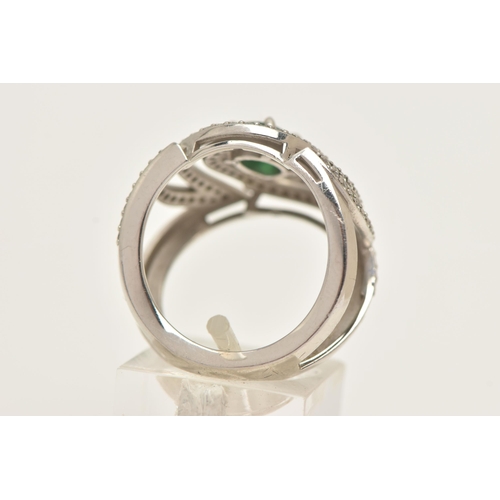 57 - A PLATINUM EMERALD AND DIAMOND DRESS RING, large dress ring set with a central oval cut emerald, in ... 