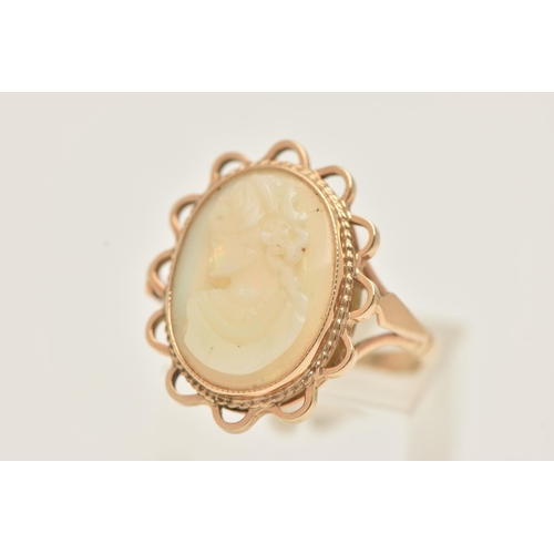 61 - A 9CT GOLD OPAL CAMEO RING, an oval opal carved with a cameo depicting a female portrait, collet set... 