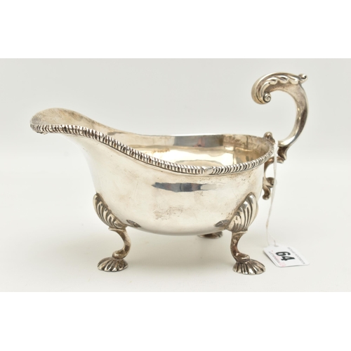 64 - A GEORGE V SILVER GRAVY BOAT, polished form with gadrooned rim, scrolling handle with leaf thumb res... 