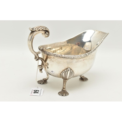 64 - A GEORGE V SILVER GRAVY BOAT, polished form with gadrooned rim, scrolling handle with leaf thumb res... 