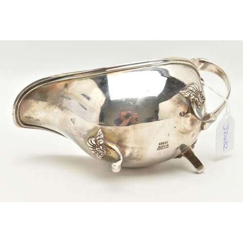 65 - AN ELIZABETH II SILVER GRAVY BOAT, polished form with scroll handle and shell detailed thumb rest, r... 