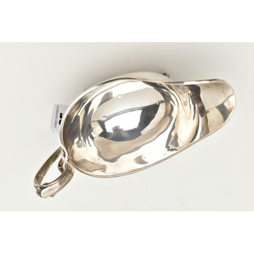 65 - AN ELIZABETH II SILVER GRAVY BOAT, polished form with scroll handle and shell detailed thumb rest, r... 