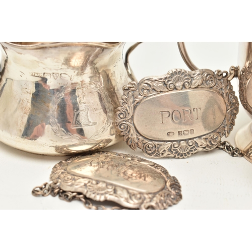 67 - A SILVER SUGAR BOWL, CUP AND THREE DECANTER LABELS, the polished sugar bowl, fitted with double hand... 