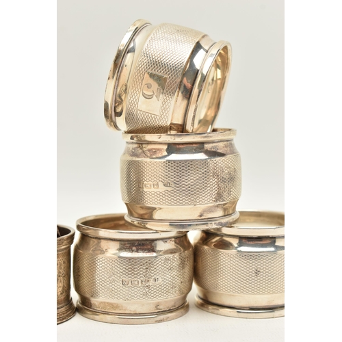 72 - A PARCEL OF SILVER NAPKIN RINGS, four engine turned pattern rings with engraved cartouche, hallmarke... 