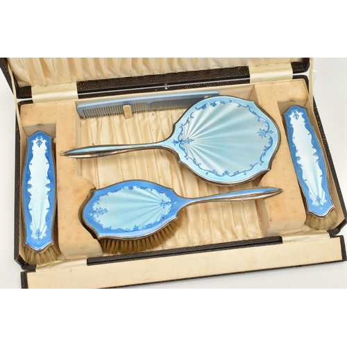 81 - A CASED SILVER AND BLUE GUILLOCHE ENAMEL VANITY SET, comprising of a hand held mirror, hair brush, t... 